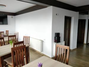 a dining room with a table and chairs at Pensiunea Simiriam Apuseni, Padis in Padis