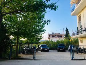 a group of cars parked in a parking lot at Lovely Apartments D in Patra