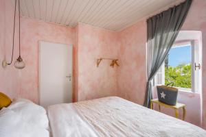 a bedroom with a bed and a window at Central, Quiet & Romantic Apartment in Herceg-Novi