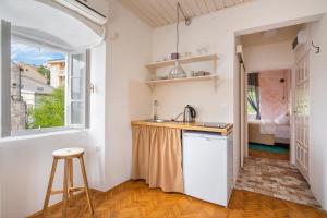 a kitchen with a sink and a counter top at Central, Quiet & Romantic Apartment in Herceg-Novi
