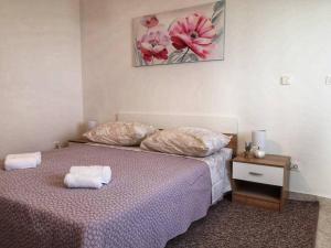 a bedroom with a bed with two pillows on it at Apartman ANAMARIA in Klis