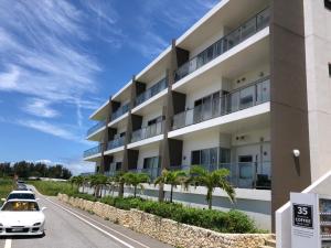 an apartment building with cars parked in front of it at Ocean Resort Maeda / Vacation STAY 3223 in Onna