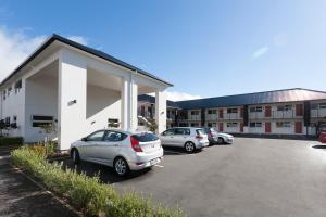 un gruppo di auto parcheggiate in un parcheggio di The Dawson Motel a New Plymouth