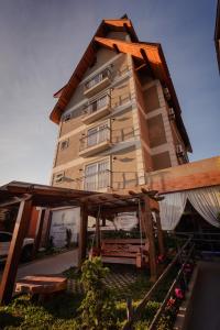 a large building with balconies on the side of it at Alameda Alegra Hotel in Gramado