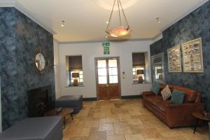 a living room with a couch and a fireplace at Gwesty Nanhoron Arms Hotel in Nefyn