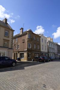 a city street with cars parked in front of buildings at 1 HAVANNAH COURT in Kelso