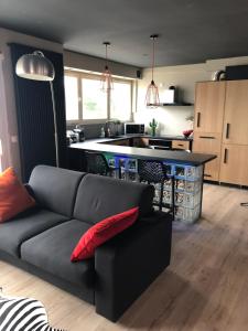 a living room with a couch and a kitchen at Appartement type loft La Baule centre in La Baule