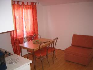a kitchen with a table and chairs and a window at Apartment Andrea in Novi Vinodolski