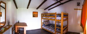 a room with two bunk beds and a desk at Kitka Hostel - Vratnica in Tetovo