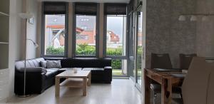 a living room with a couch and a table at FeWo an der Ostsee Nr. 2 in Rerik