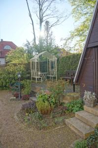 a garden with a gazebo and stairs next to a house at Hotel-Appartement-Villa Ulenburg in Dresden