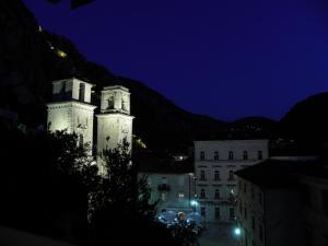 um edifício com duas torres à noite em Hotel Villa Duomo em Kotor