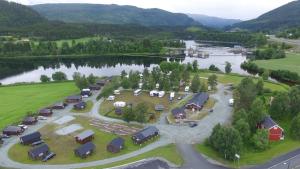 an aerial view of a campgrounds next to a river at Harran Camping in Grong