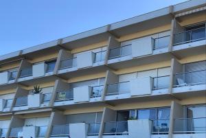 an apartment building with balconies on the side at LACANAU FRONT DE MER in Lacanau