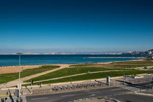 a view of a beach and the ocean with bikes at Hôtel Le Mistral in Marseille