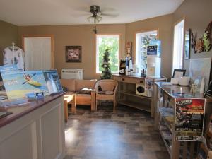 a kitchen and living room with a table and a couch at Shine Motel in Summerside