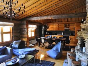 a living room with a blue couch and a table at Ruka Aava in Ruka