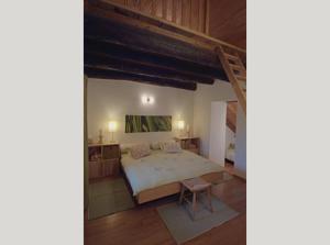 a bedroom with a large bed and a chair at Pensione Boschetto in Cevio +22 photos