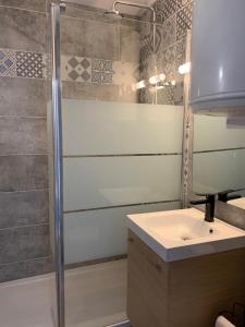 a bathroom with a shower and a sink at LACANAU FRONT DE MER in Lacanau