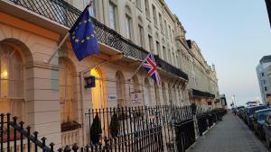 two british flags on the side of a building at Andorra Guest Accommodation in Brighton & Hove