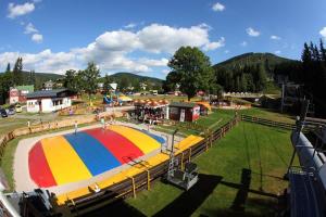 a fair with a large colorful circle in a park at Apartmány Mamut Harrachov in Harrachov