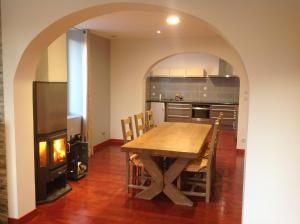 a dining room with a table and a fireplace at L'Apogée in Thoirette