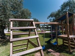 two wooden play structures in a park at Fokas Luxury Villa in Prinos