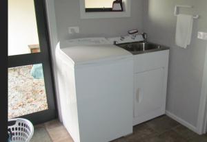 a small bathroom with a sink and a counter at Birchwood Cottages in Te Anau