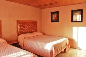 Postel nebo postele na pokoji v ubytování Villas La Quinta
