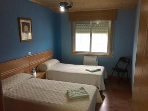 a room with two beds and a window at Apart. cerca de Playa Catedrales in Lourenzá