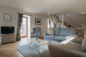 a living room with a couch and a table at The Blue Hoose in Gardenstown