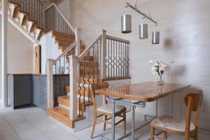 a dining room with a wooden table and stairs at The Blue Hoose in Gardenstown