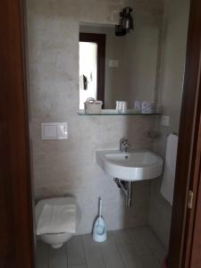 a bathroom with a sink and a toilet at Casa Barbara in Marzamemi