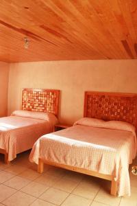 Postel nebo postele na pokoji v ubytování Villas La Quinta