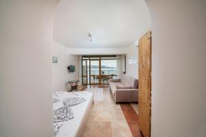 a living room with a couch and a table at Sozopol Seaside Apartment in Sozopol