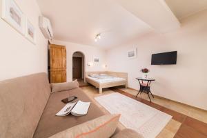 a living room with a couch and a table at Sozopol Seaside Apartment in Sozopol