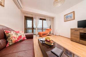 a living room with a couch and a table at Sozopol Seaside Villa in Sozopol