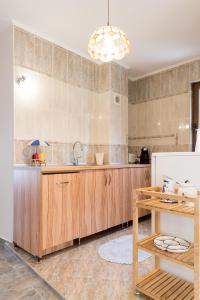 a kitchen with wooden cabinets and a sink at Sozopol Seaside Villa in Sozopol