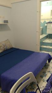 a bedroom with a bed with a purple blanket at La conchiglia in Minori +47 photos