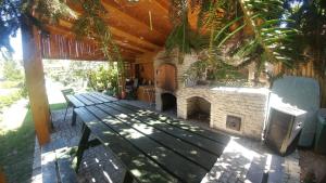 a patio with a bench and a stone fireplace at Noclegi Pod Bocianem in Nysa