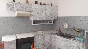 a kitchen with a sink and a counter top at City Center First Floor Apartment in Kos +113 photos