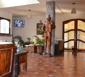 a statue of a man standing in a living room at Casa Grande in Zacatlán