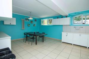 cocina con mesa y pared azul en Student-House Kazimierzowska, en Varsovia