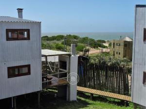 un balcón de una casa con el océano en el fondo en Casas Sadhana en Punta del Diablo