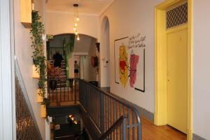 a hallway with a staircase with a yellow door at Britannia on William in Perth