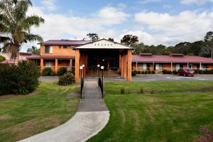 a large building with a patio and a walkway at Nightcap at Archer Hotel in Nowra