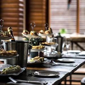 a table topped with plates of food and desserts at Jenkins Street Guesthouse in Nundle