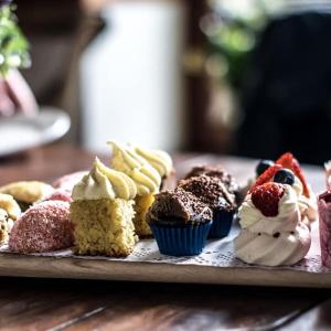 a tray of different types of desserts on a table at Jenkins Street Guesthouse in Nundle