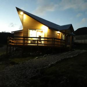 a small house with a light on the side of it at Ventisca Sur in Coihaique