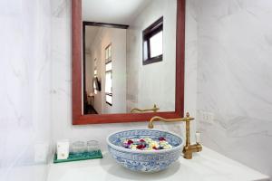 a bathroom with a bowl sink and a mirror at Sound Gallery House Phuket Town in Phuket +38 photos